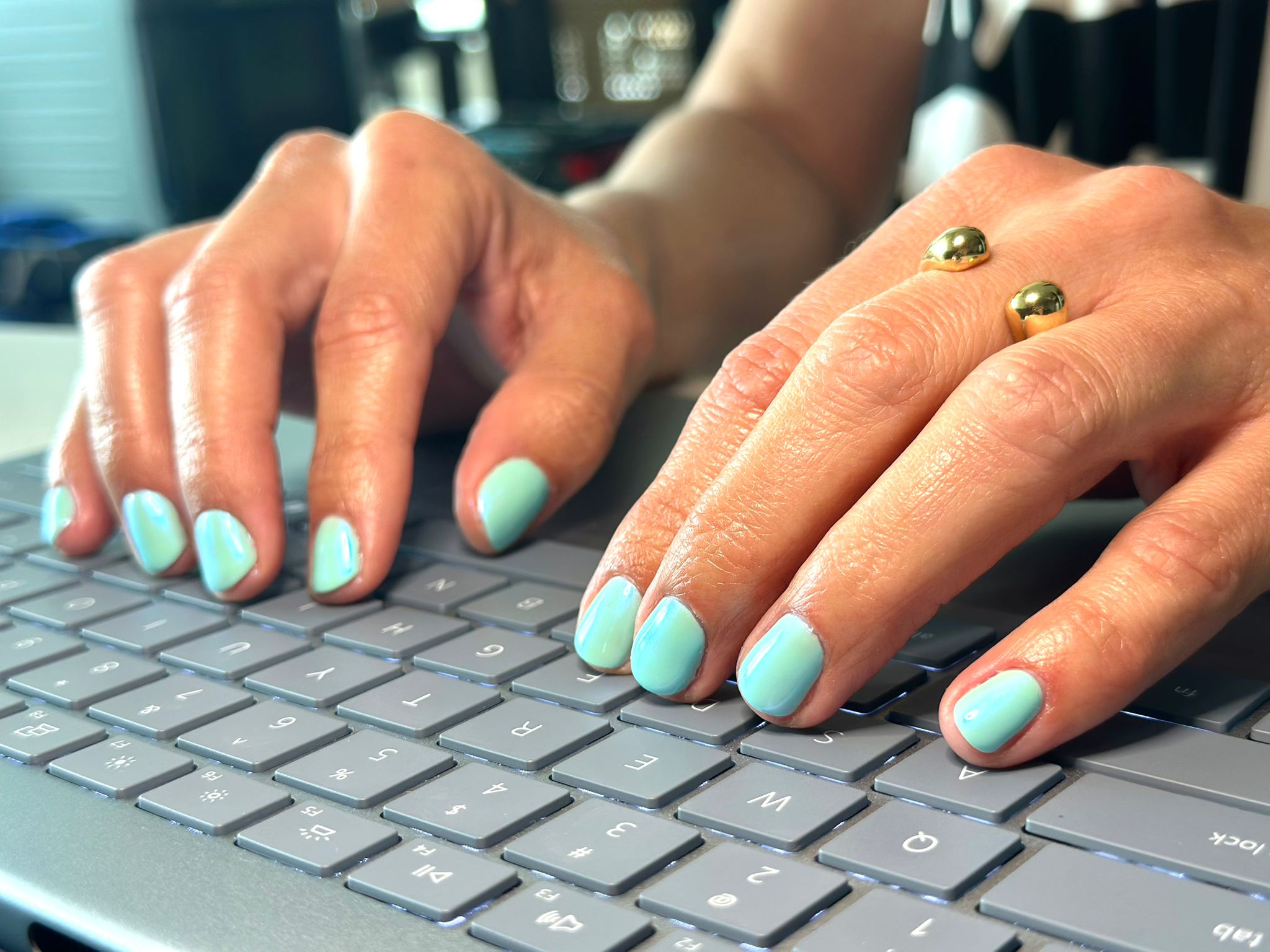 Bright sea green colored nail manicure.